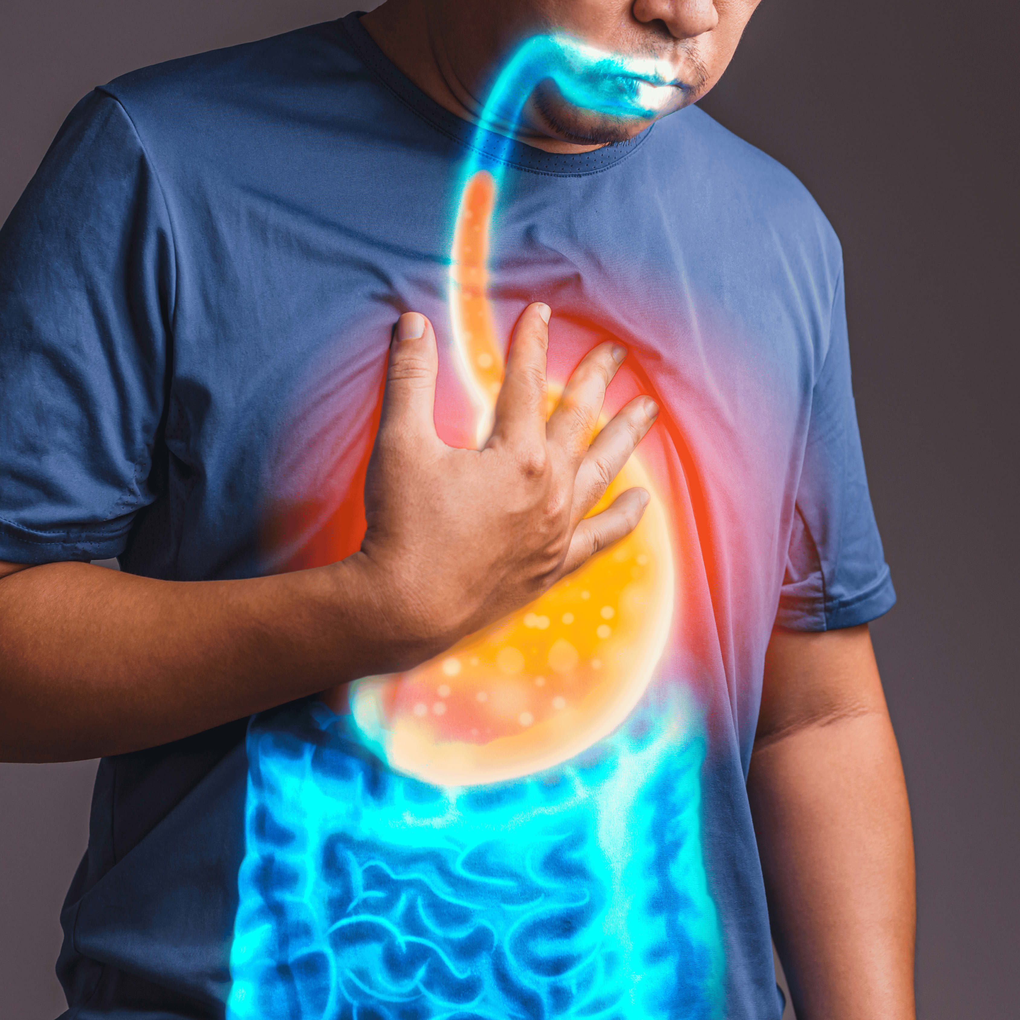 An elderly man clutching his chest with discomfort, showing symptoms of heartburn or acid reflux