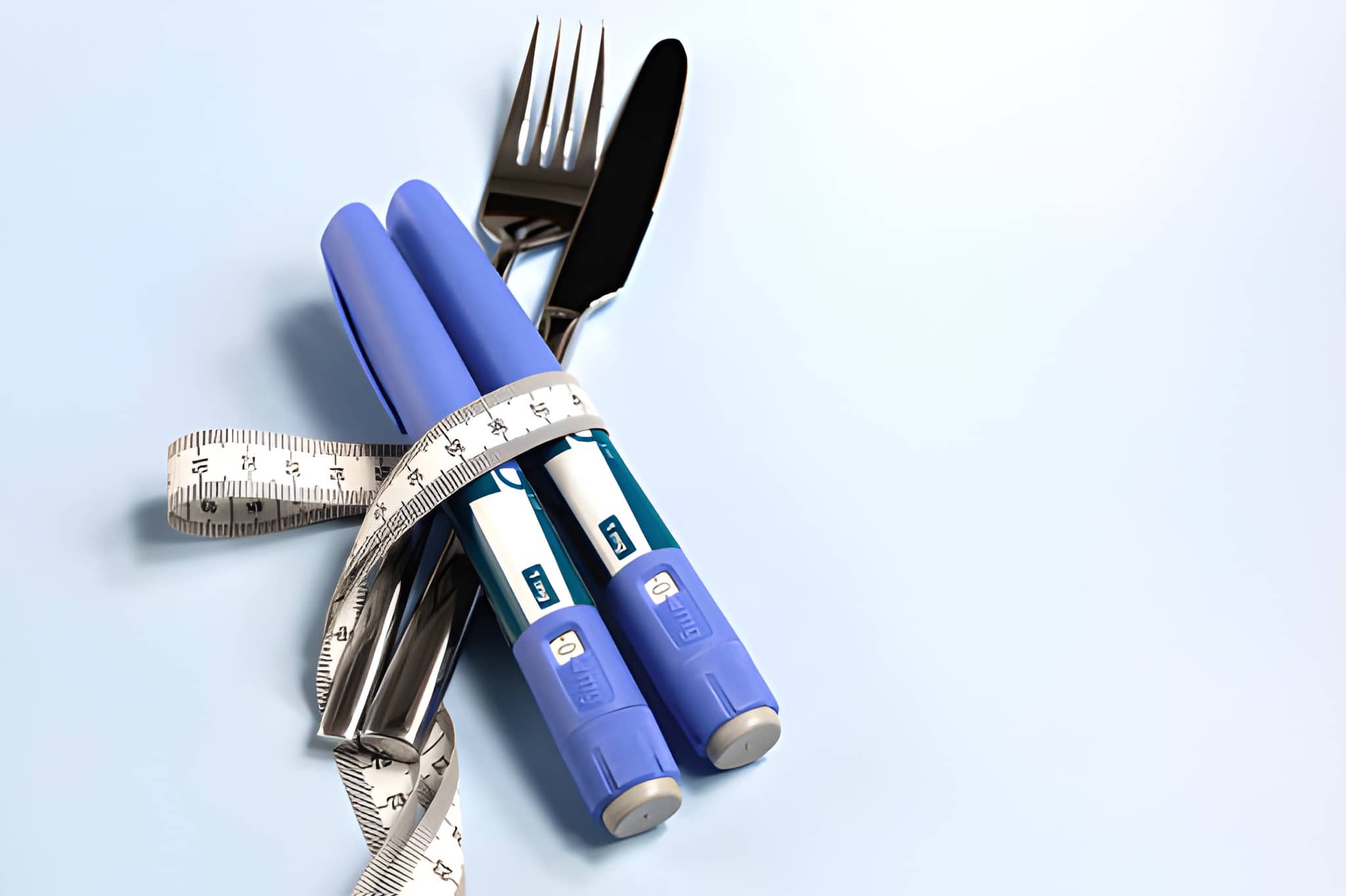 Diabetes injection pens with fork, knife, and measuring tape symbolizing diet-based natural cure for type 2 diabetes.