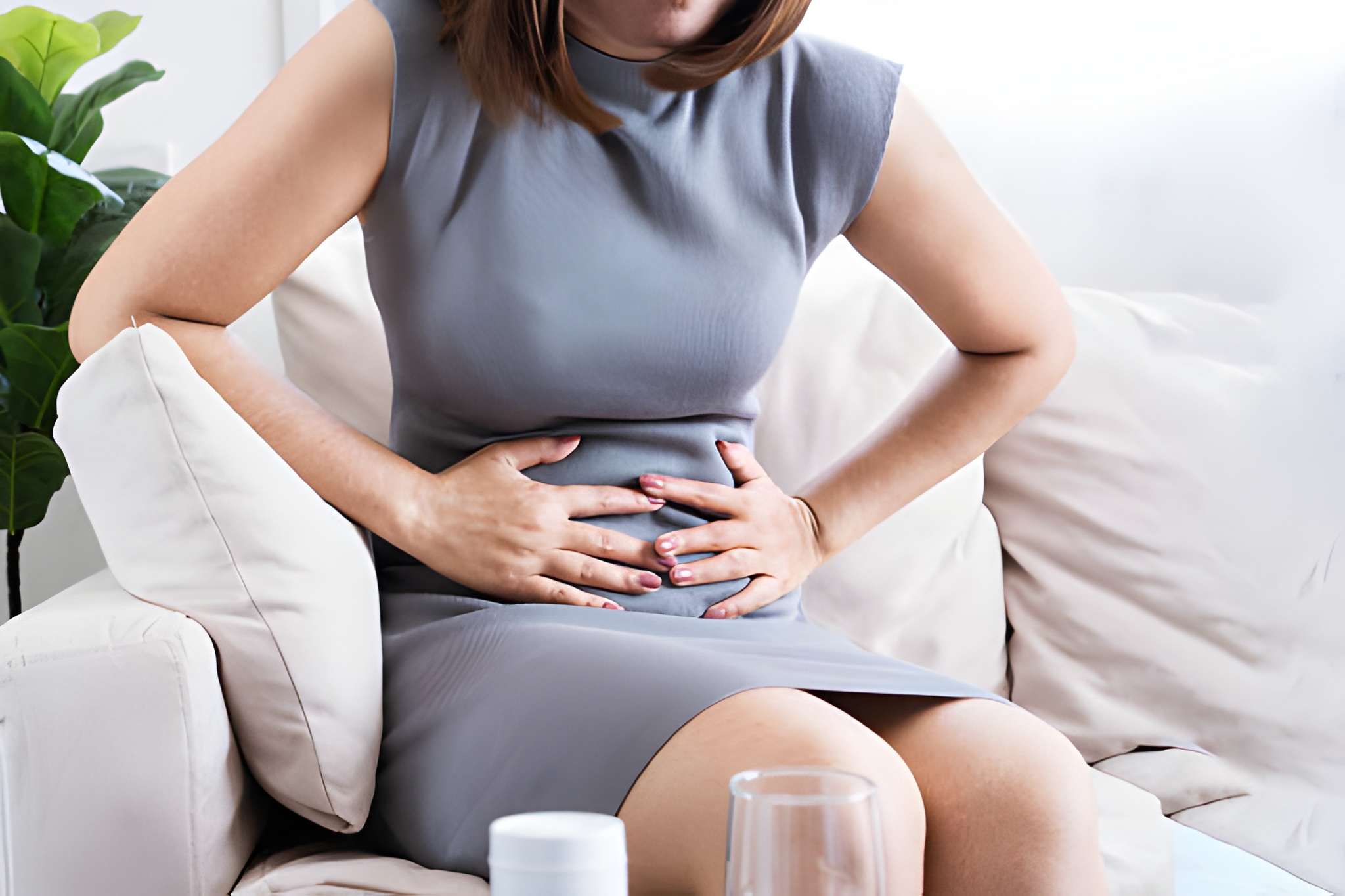 Ayurvedic for gastritis concept showing a woman holding her stomach due to acidity and digestive discomfort