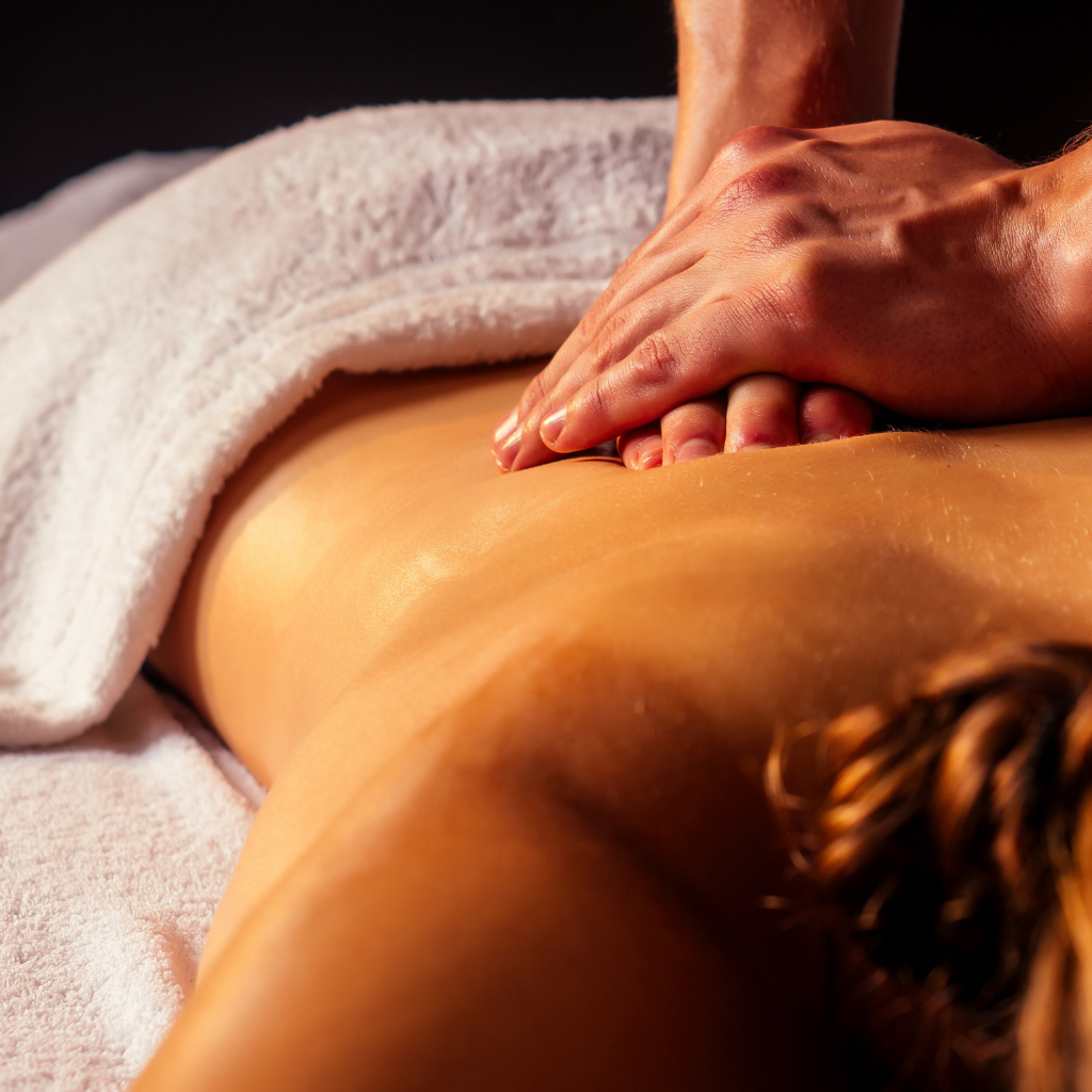 Therapist performing Ayurvedic massage as part of Panchakarma treatment for back pain and muscle relaxation.
