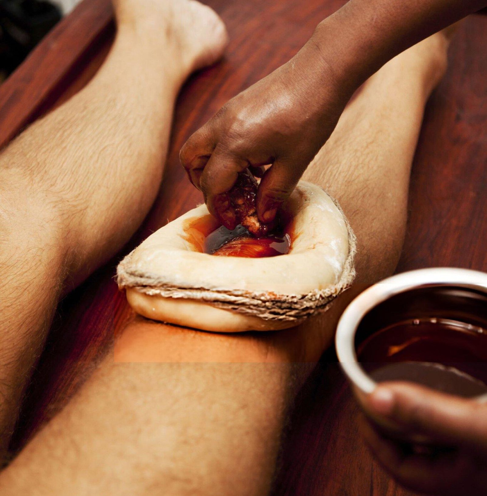 Joint Pain Ayurveda therapy with medicated herbal oil applied to the knee during a traditional Ayurvedic treatment for joint pain relief and improved mobility.