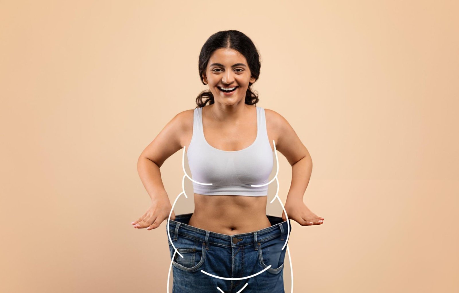 Woman showing significant weight loss by wearing oversized jeans, representing the benefits of Ayurvedic Weight Loss Treatment in Kerala through natural therapies and healthy lifestyle changes.