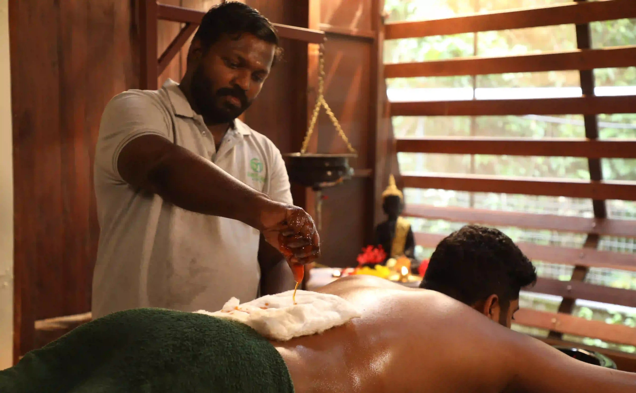 Ayurveda Treatment for Menopause featuring traditional Pizhichil therapy with warm medicated oil applied to the back to promote relaxation, hormonal balance, and overall well-being.